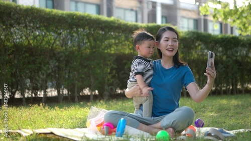 While in vacation at home, a mother engages in activities with little kid in the park