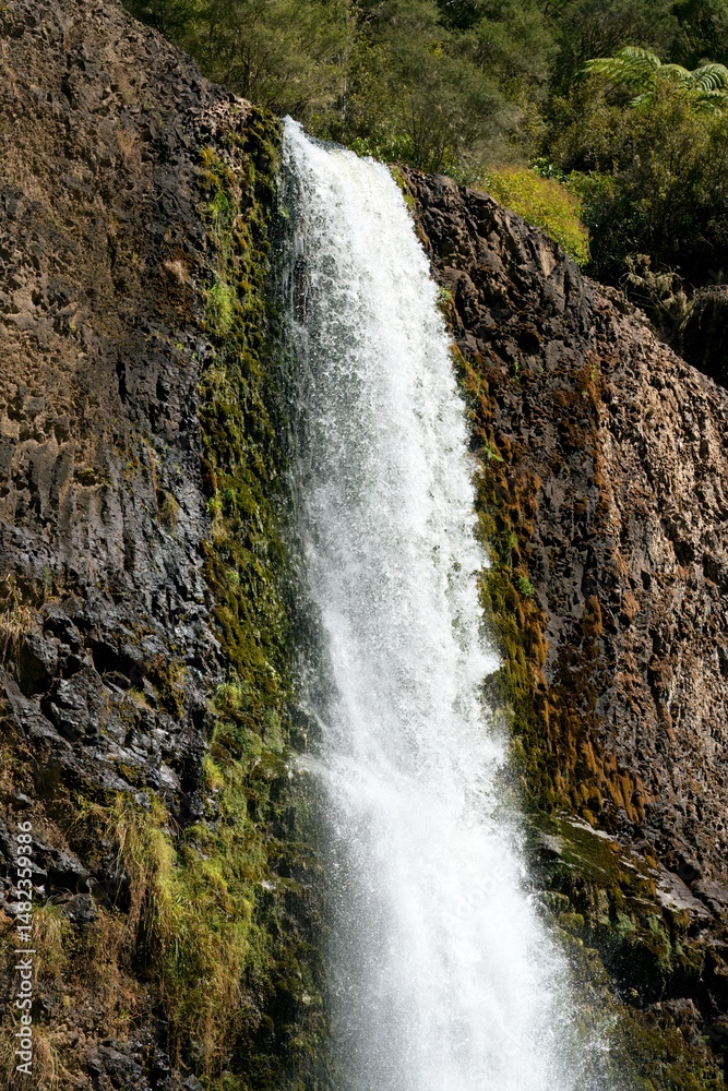 Fototapeta premium Close-up view of Hunua Falls cascading over rocky cliff