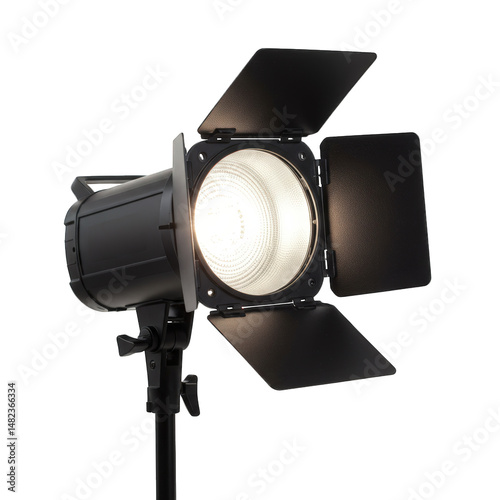 Studio fresnel spotlight with barn doors and stand, turned on isolated background