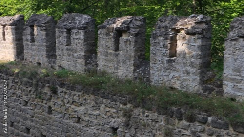 A view of a battlemented stone wall inside a medieval castle