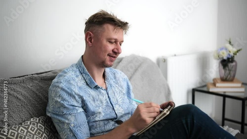 Young Man Notes A Shopping List