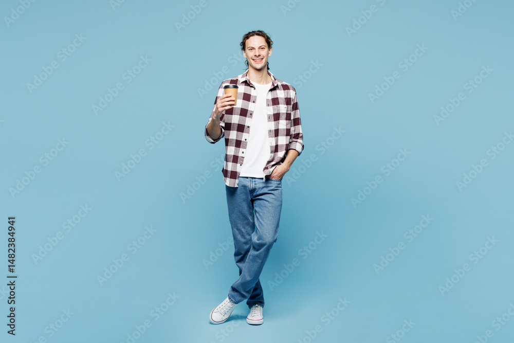 Fototapeta premium Full body young man wear purple checkered shirt casual clothes hold takeaway delivery craft paper brown cup coffee to go isolated on plain pastel light blue cyan background studio. Lifestyle concept.
