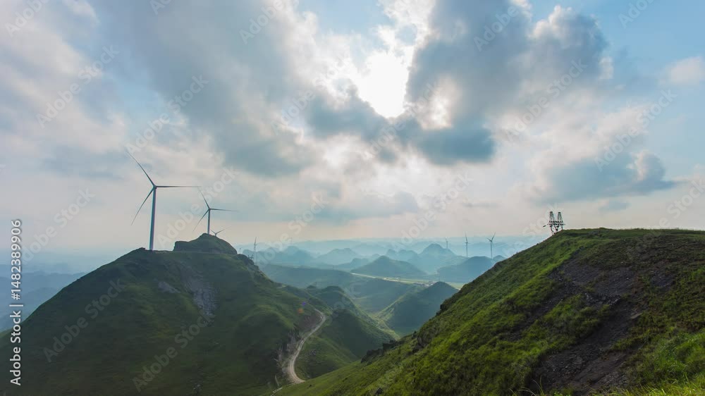 Timelapse view of windmills generating power in mountain landscape