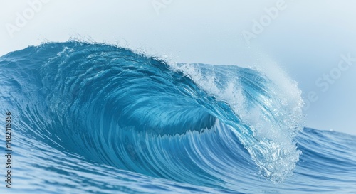 Powerful ocean wave crashing with vibrant blue colors against a serene sky