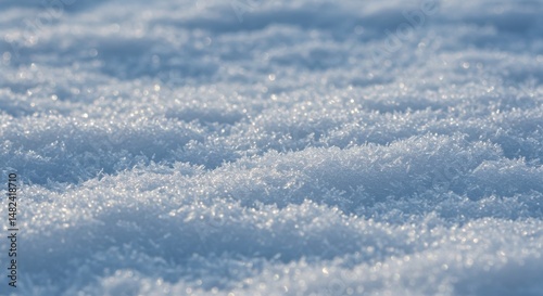 Close-up of glistening snow texture with soft undulations in bright sunlight