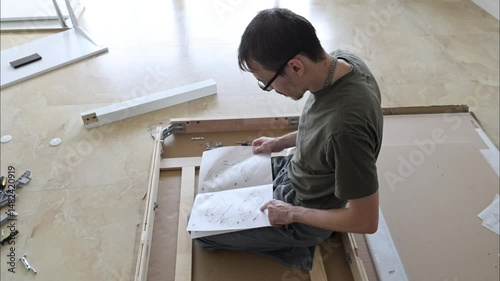 Studying manual before assembling flat pack furniture