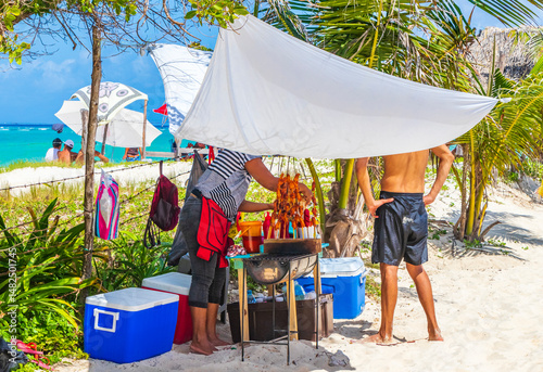Fototapeta Naklejka Na Ścianę i Meble -  People buying food at tropical beach Playa del Carmen Mexico.
