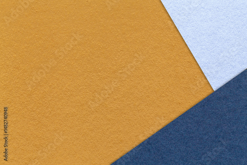Texture craft dark yellow paper background with sky and navy blue border. Vintage ocher cardboard.