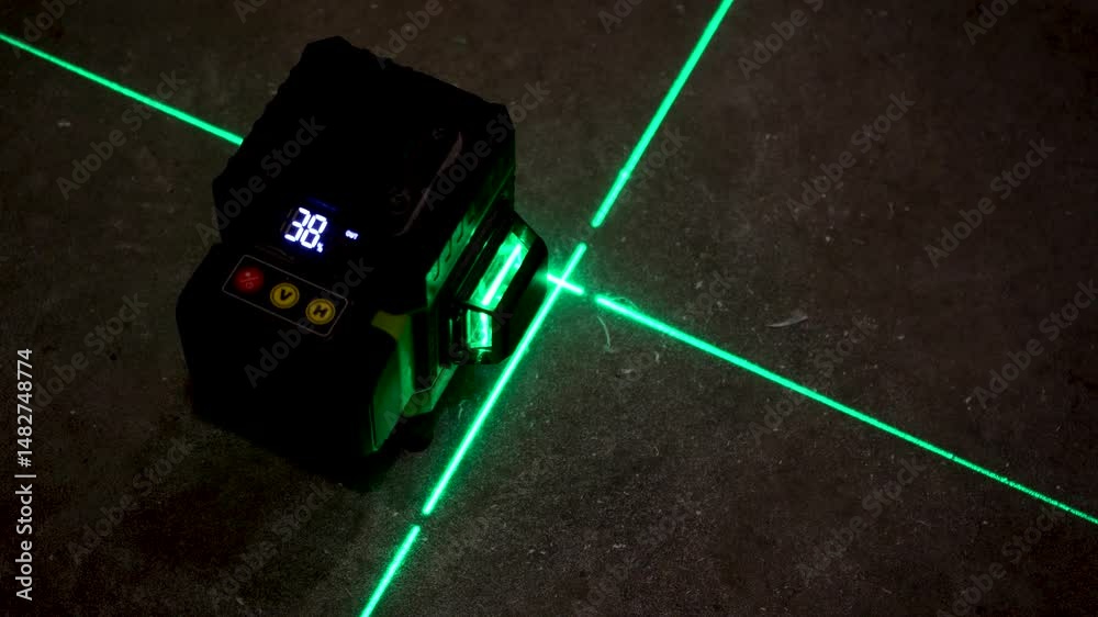 The overlapping green laser lines on the floor provide a clear guide for planning and marking out in an unfinished space.