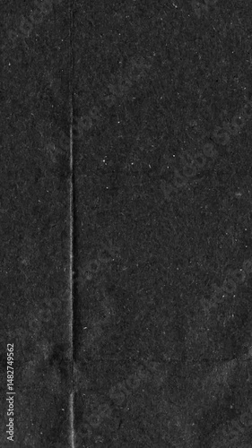 Black kraft paper noise texture vertical stop motion video. Old page overlay effect background loop animation. Vintage paper texture with crease, stain, grain, dust particles. Empty animated backdrop