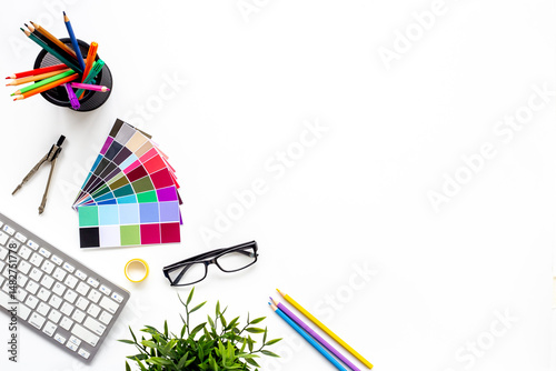 Color paint swatches and decorator or designer tools for work. Desktop flat lay, top view