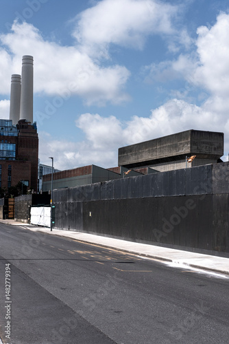 Wide urban street scene with industrial buildings, minimal lines and clear sky, offering copy space and depth in contemporary city design. Emptiness as modern visual concept. photo