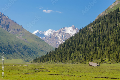 Tian Shan mountains glacier and snow summits on a sunny day with blue sky. Kyrgyzstan mountains on the border with China high altitude snow and glacier trek, climbing and alpinism in the wilderness