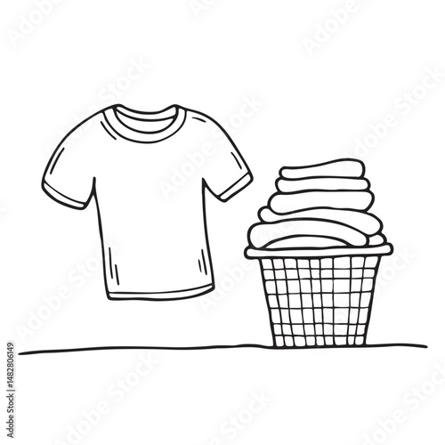 A T shirts on the floor near a laundry basket