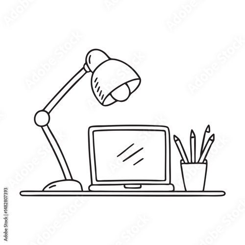 A table lamp placed next to a laptop on a study table