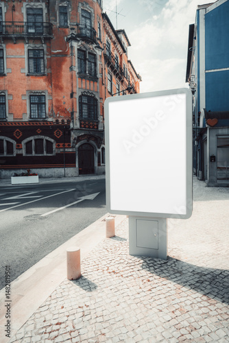 Wallpaper Mural Blank vertical outdoor advertising billboard in an urban environment with a historic building in the background. The empty white sign is ready for customization, standing on a sidewalk near the street Torontodigital.ca