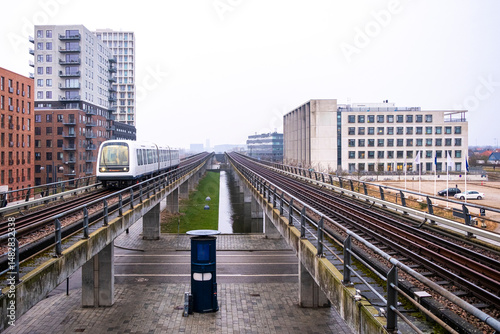 Elevated metro railway crossing through Ørestad’s urban landscape. Central perspective and symmetry define this minimalist image of infrastructure and contemporary mobility.