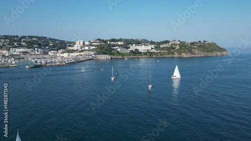 Torquay, Torbay, South Devon, England: DRONE VIEWS: Yacht club members sailing near Torquay marina. Torbay is a popular UK holiday destination and a magnet for water sports enthusiasts (Clip 11).