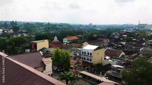 A vibrant atmosphere of Surakarta city, where tradition and modernity blend seamlessly. The city is filled with cultural landmarks, bustling markets, historical architecture, and the warmth of Javanes