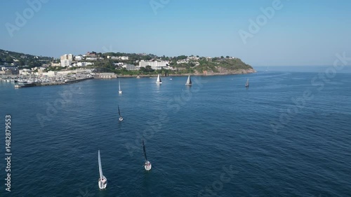 Torquay, Torbay, South Devon, England: DRONE VIEWS: Yacht club members sailing near Torquay marina. Torbay is a popular UK holiday destination and a magnet for water sports enthusiasts (Clip 10).
