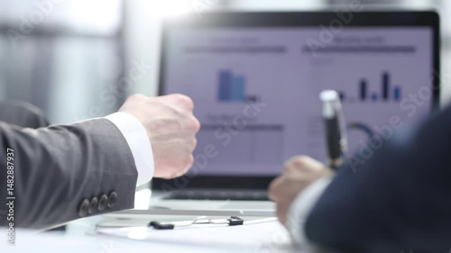 Businessmen discuss a business plan in the office with a laptop