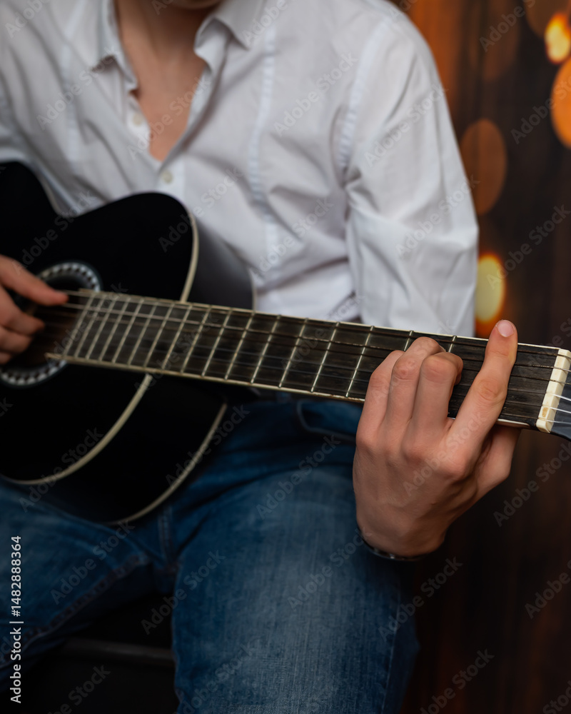 Fototapeta premium man hands playing guitar