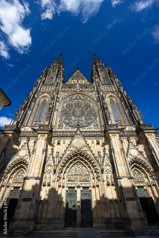 Fototapeta premium St. Vitus Cathedral rising majestically against a blue sky in Prague