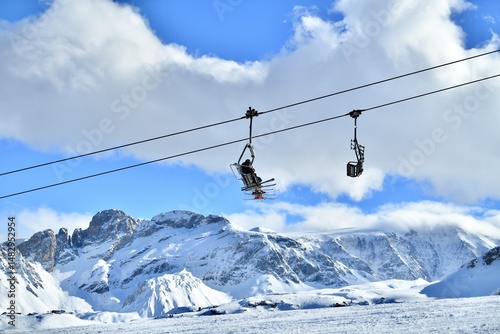 Ski lifts and skiers on the slopes Courchevel ski resort by winter