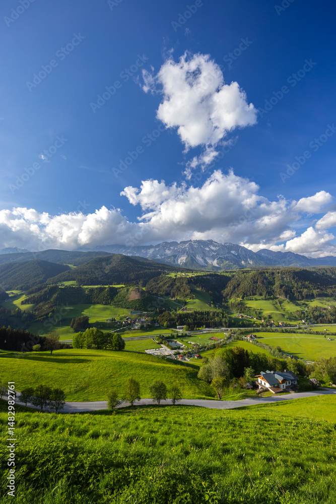 Obraz premium Dachstein Glacier towering over Schladming valley in Styria, Austria, during a sunny spring day