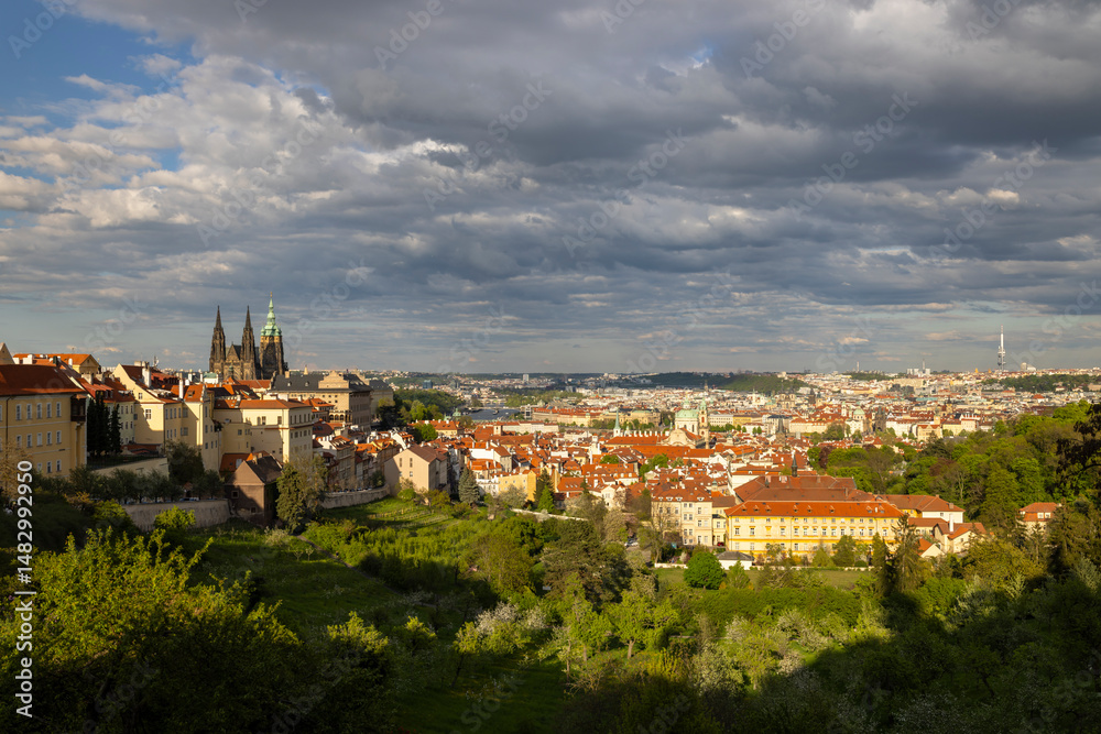 Fototapeta premium Prague Castle dominating the cityscape under dramatic cloudy sky in Czechia