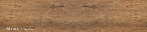 Panorama of wooden surface with knots and grain textures.