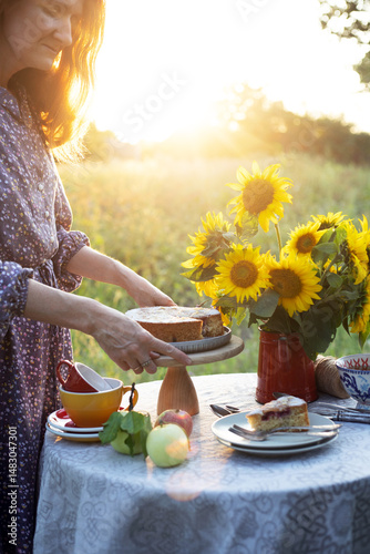 girl serving tea table in the garden