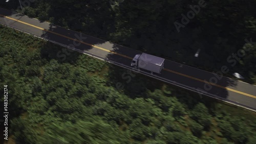 White logistics vehicle carrying the ordered supply items on the roadway. Logistics car transporting the supply goods on the roadway. Logistics company moving the supply chain products on a roadway.