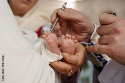Cuadro en lienzo A tender moment of a baby's christening ceremony, with a priest anointing the in