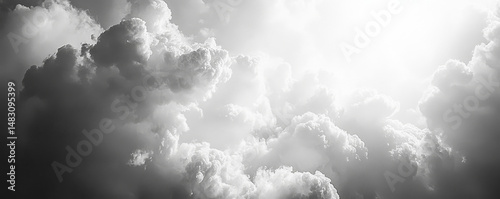 Dramatic sky with towering clouds illuminated by bright sunlight, creating a serene yet powerful atmosphere.