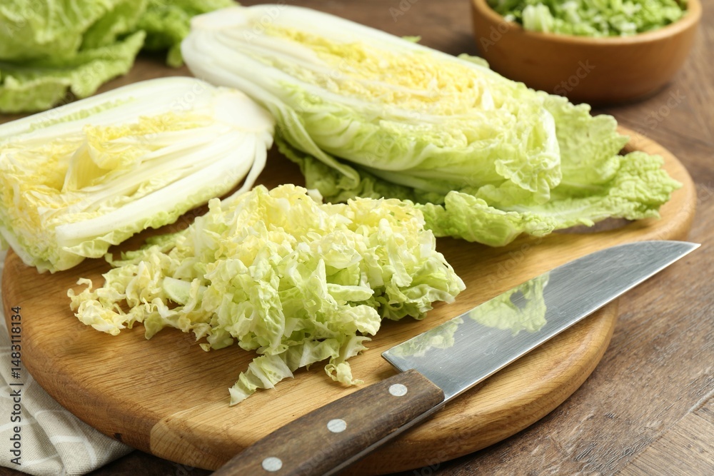 Fresh Chinese cabbages and knife on wooden table, closeup Fresh Chinese cabbages and knife on wooden table, closeup