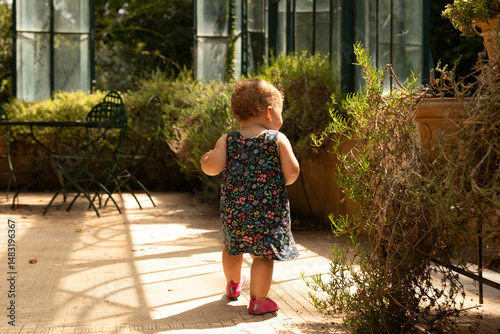Adorable baby girl explorin...