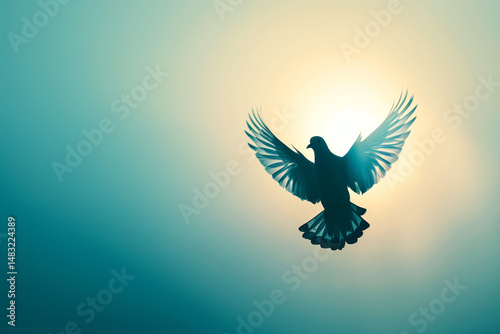 Dove in flight with symbolic mood soaring in front of glowing sun against teal sky background with copy space
