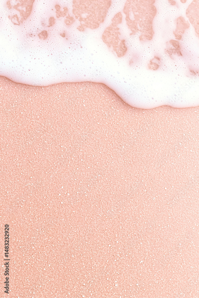 Fototapeta premium Pink sand beach with gentle waves and soft foam creating serene and tranquil atmosphere