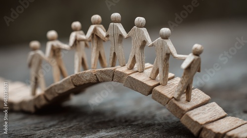 People walking over a wooden arch bridge