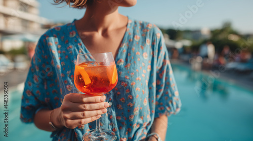 Women Standing by the Pool and Holding Glass of Aperol Spritz Drink