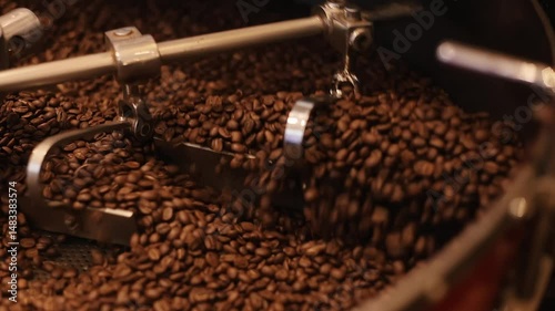 Production machine for roasting large volumes of coffee beans. High-tech equipment helps control degree of roasting, which affects taste and aroma of drink