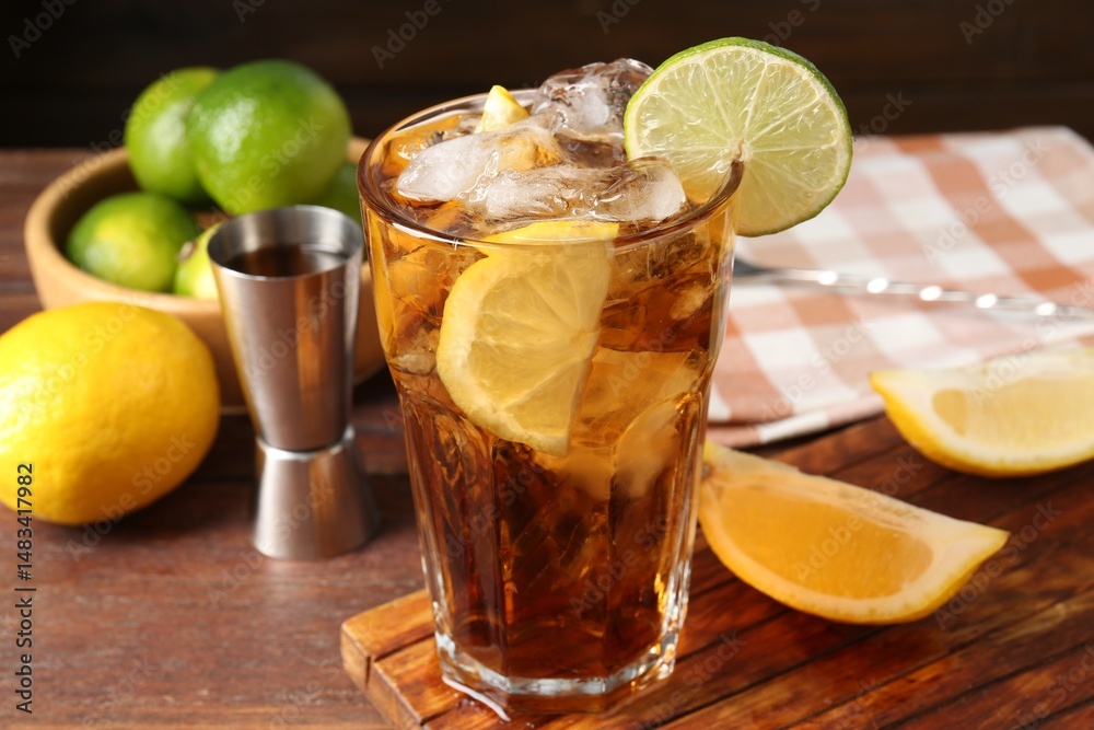 Refreshing Cuba libre cocktail and ingredients on wooden table, closeup Refreshing Cuba libre cocktail and ingredients on wooden table, closeup