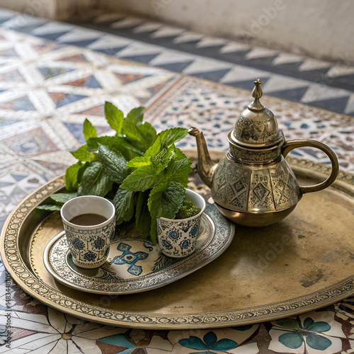 cup of tea with teapot and sugar
