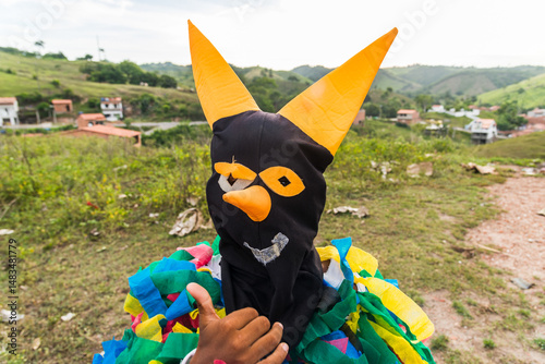 Unidentified person dressed in terrifying costume and mask. Rural cultural area. photo