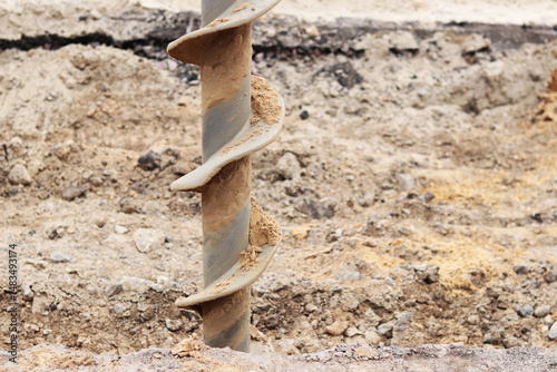Soil auger, close-up. Construction special equipment. Repair work. Construction activity at a construction site. Close-up of drilling equipment. Geotechnical drilling
