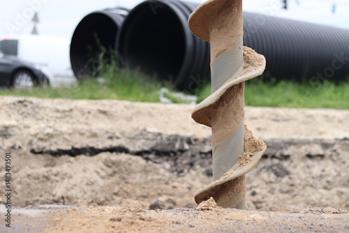 Soil auger, close-up. Construction special equipment. Repair work. Construction activity at a construction site. Close-up of drilling equipment. Geotechnical drilling