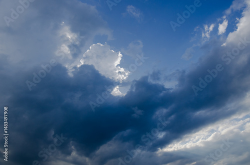 Sky with dark clouds and sun rays