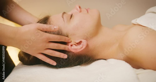 Wallpaper Mural Happy Young Woman Lying on Bed at Spa Salon and Enjoying Face Massage. Cosmetologist Massaging Female Client Face for Lymphatic Drainage and Lifting Effect. Beauty, Skin Care Concept Torontodigital.ca
