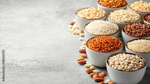 Obraz na płótnie Assortment of Grains and Nuts in Bowls on Grey Background w salonie